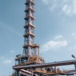 Oil refinery towers against blue sky