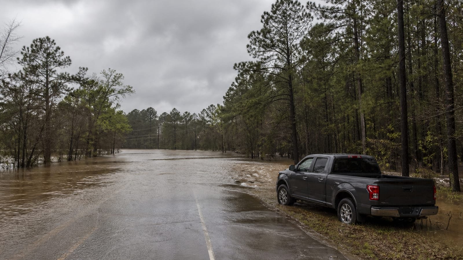 Floodwater covering a rural Texas road after a storm