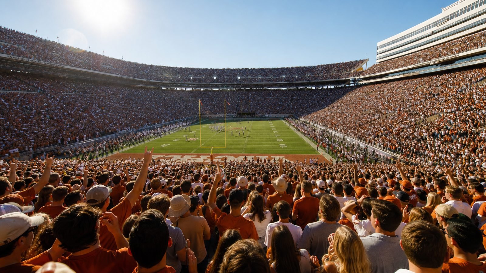 A packed college football stadium in afternoon sun