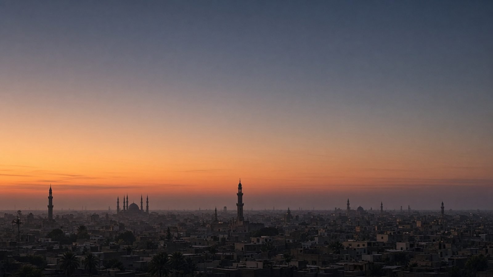 A desert city skyline at dusk with minarets in silhouette