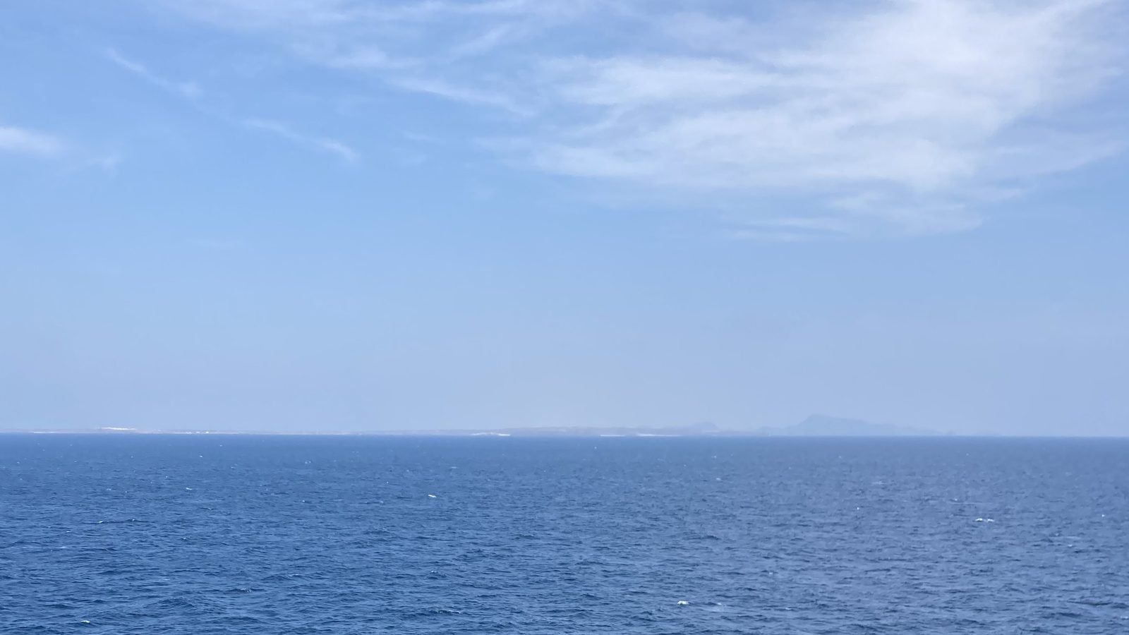 Bab el-Mandeb from mid-channel, Perim Island in the distance. Photograph by Richard Weil, CC0.