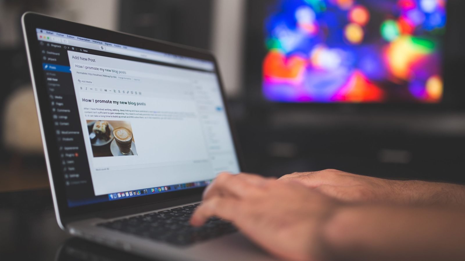 Hands typing a post on a laptop at night. Photograph by Pixabay via Pexels.